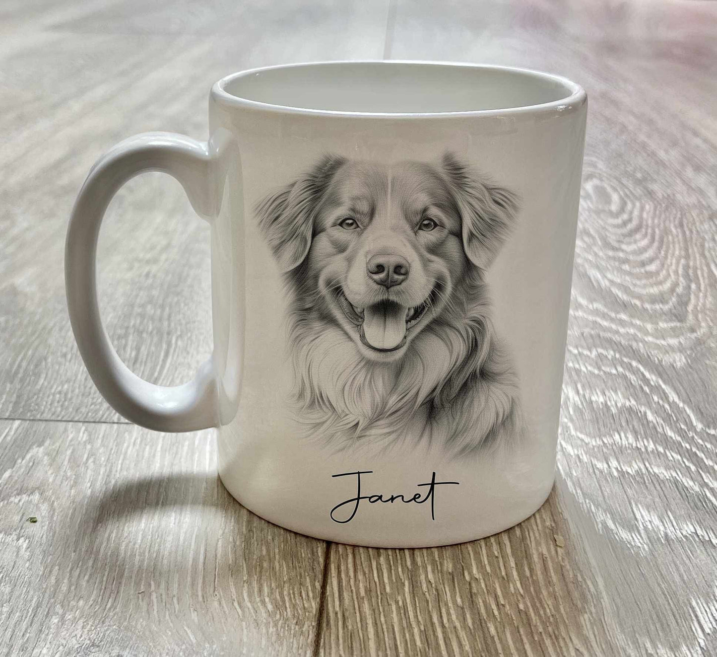 A white mug featuring a toller retriever dog in a sketchy style, with a name underneath in cursive text